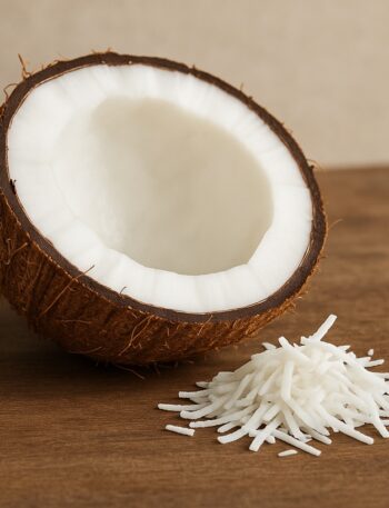 Mezzo cocco con polpa bianca e scaglie su superficie rustica