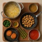 Tecniche di cottura, Pentole e padelle su tagliere rustico con cibi cotti con varie tecniche: bollitura, frittura, grigliatura, saltato, sugo e vapore