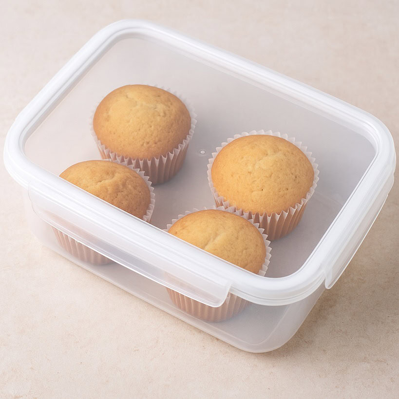 Cupcake alla vaniglia conservati in un contenitore ermetico trasparente con coperchio