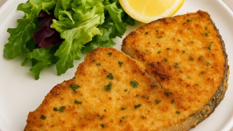 Pesce spada al forno impiattato con insalata e spicchio di limone
